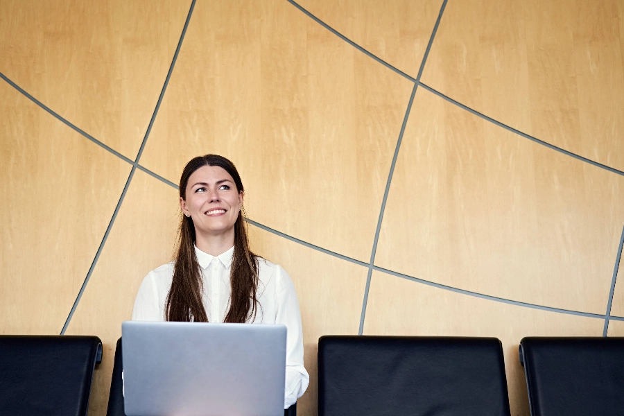 Woman working with her laptop at airport.