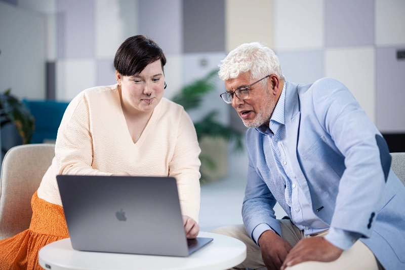 A woman and a man planning together at a computer.