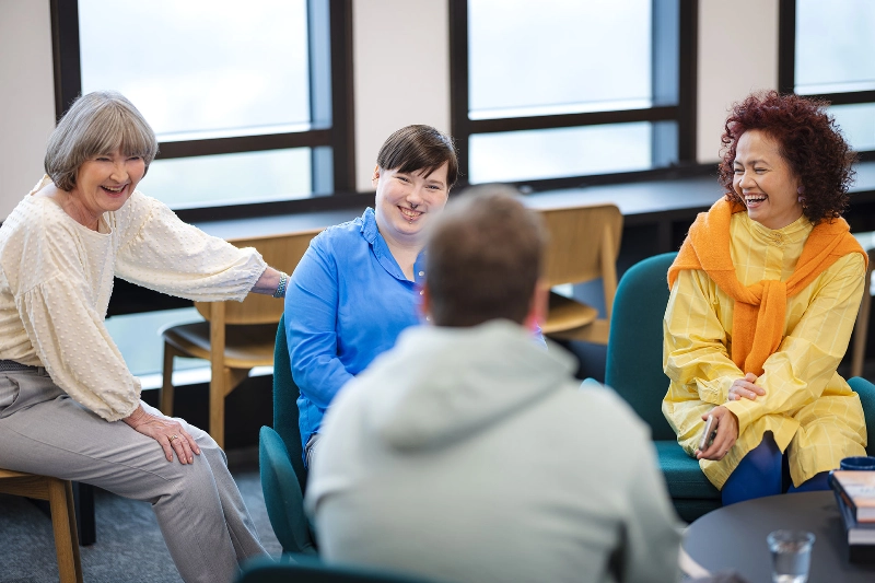 four people talking at the office
