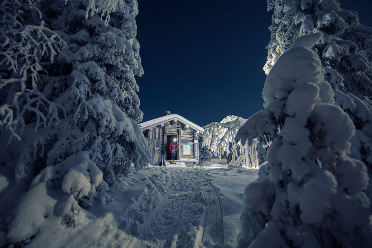 Person in a lean-in shelter in Riisitunturi National Park, Finland.