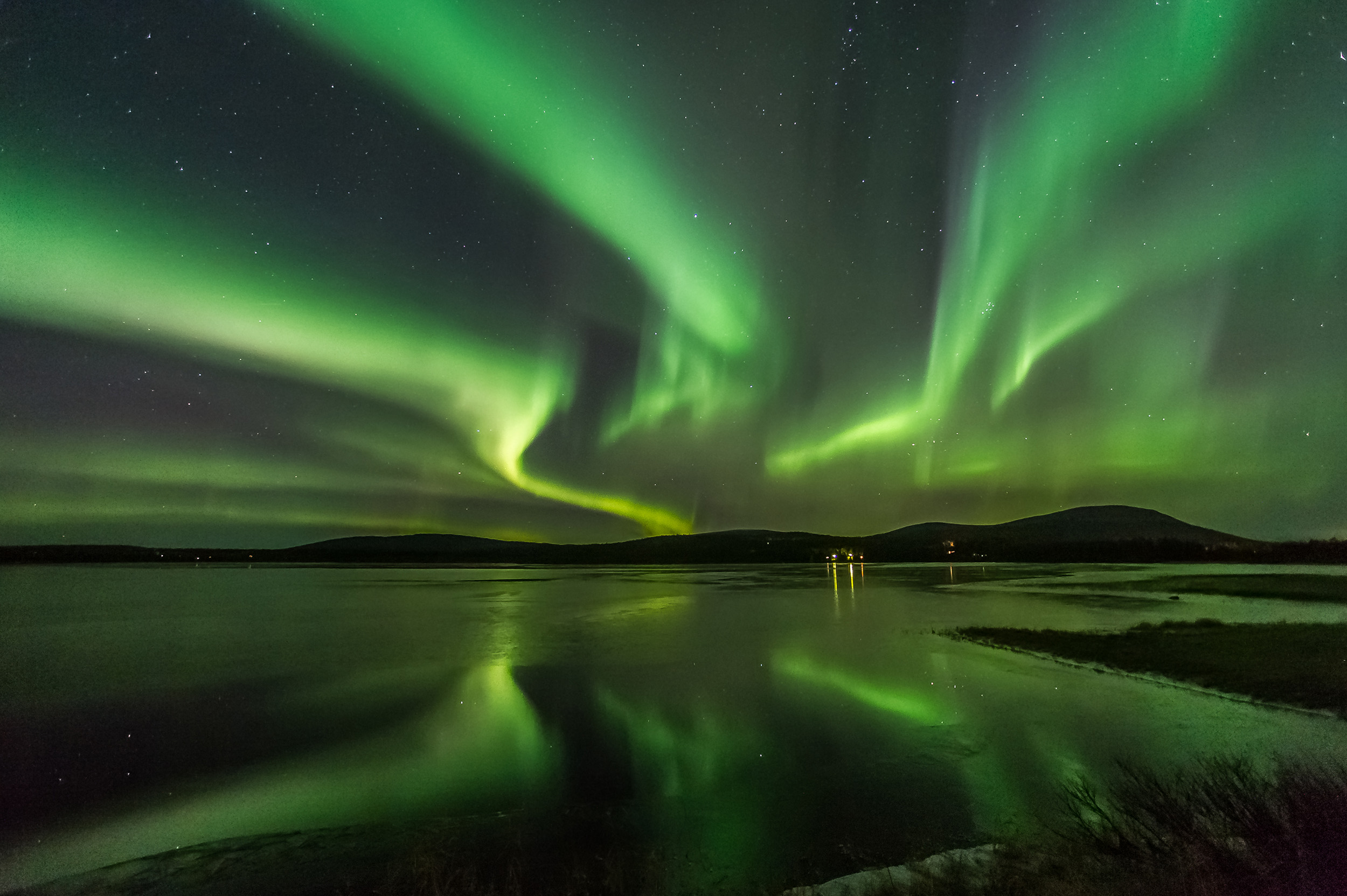 Northern Lights reflecting on a lake in Finland.