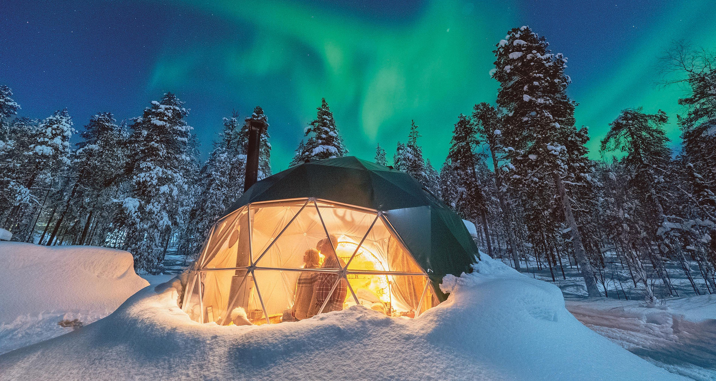 People watching the Northern Lights in a Aurora dome.